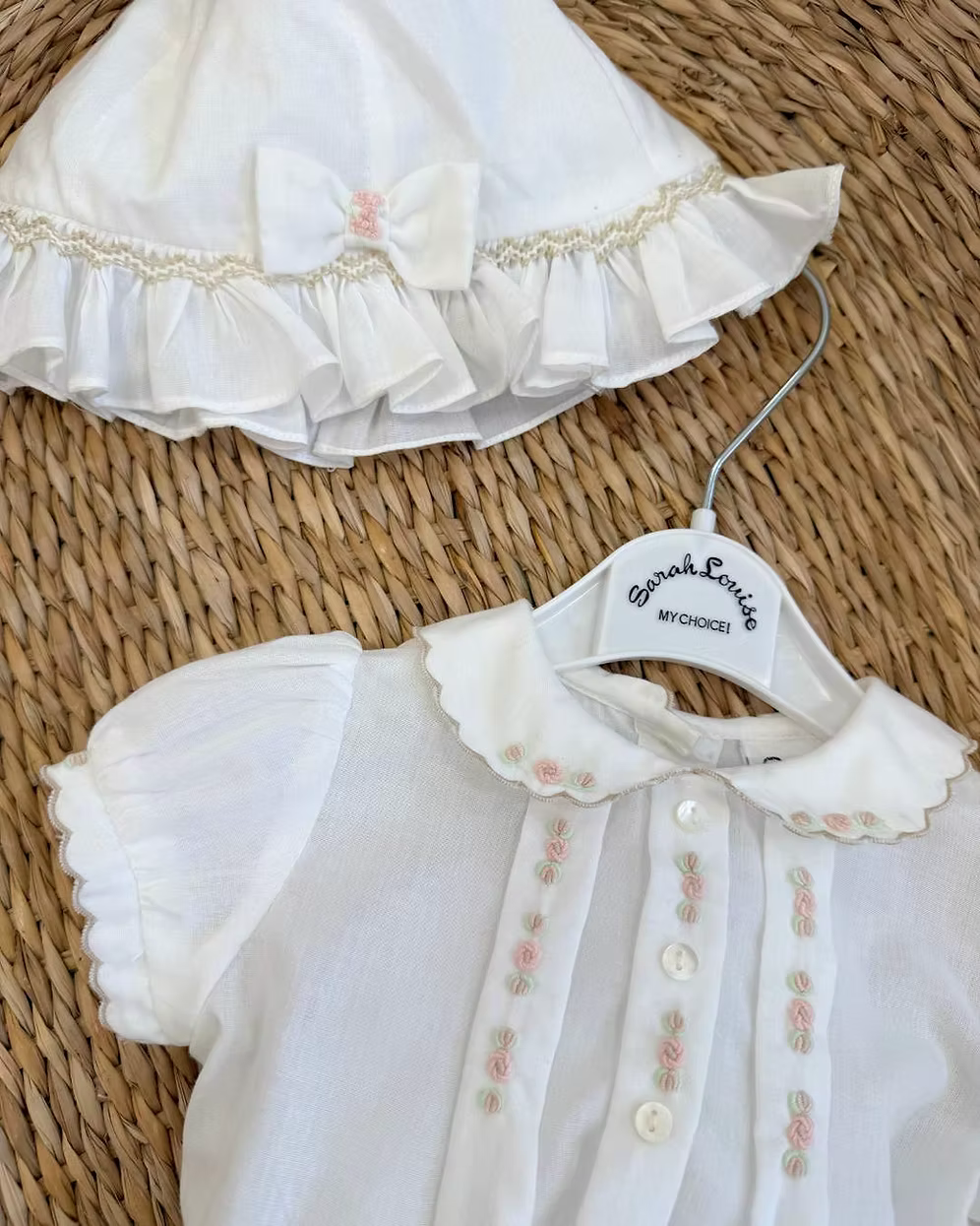 Sarah Louise x Little Lambs Heritage Girls Short Set featuring an ivory hand-smocked blouse with peach embroidery and neutral tailored shorts.