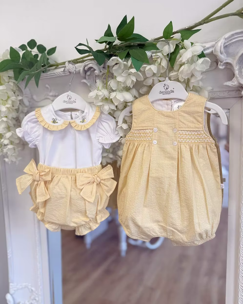Deolinda Bumble Romper featuring buttery yellow gingham, a smocked chest panel, pleat detailing, button accents and a classic unisex design.