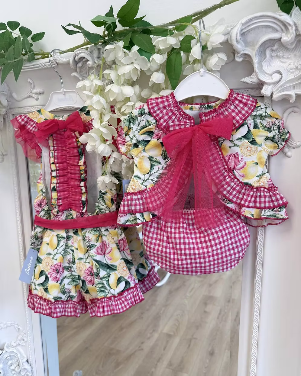 Babine Lemon Blossom Swing Back Dress & Pants featuring a lemon and pink floral print, open swing back, large tulle bow, frill collar, and matching pink gingham pants.