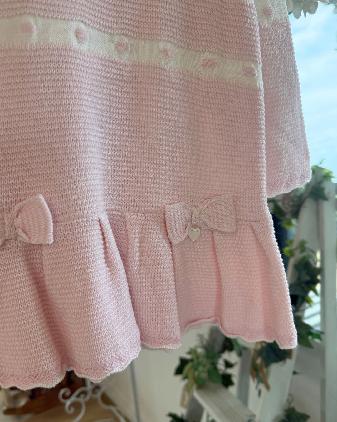Bluesbaby Marie baby pink and cream knitted girls dress with frill collar, bows and pleated skirt.