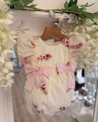 Phi lemon bubble romper with a pink cherry blossom print and two large pink bows on the waist