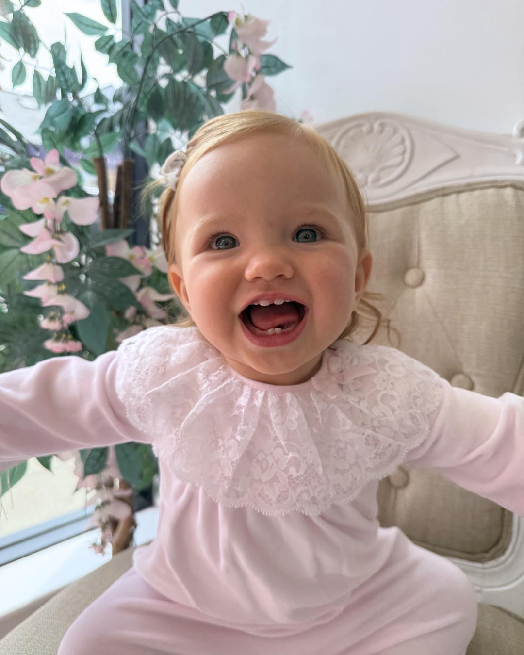 Bluesbaby Elodie Lace Velour Babygrow in baby pink with white lace frill collar, velvet bow and matching pink baby hat.
