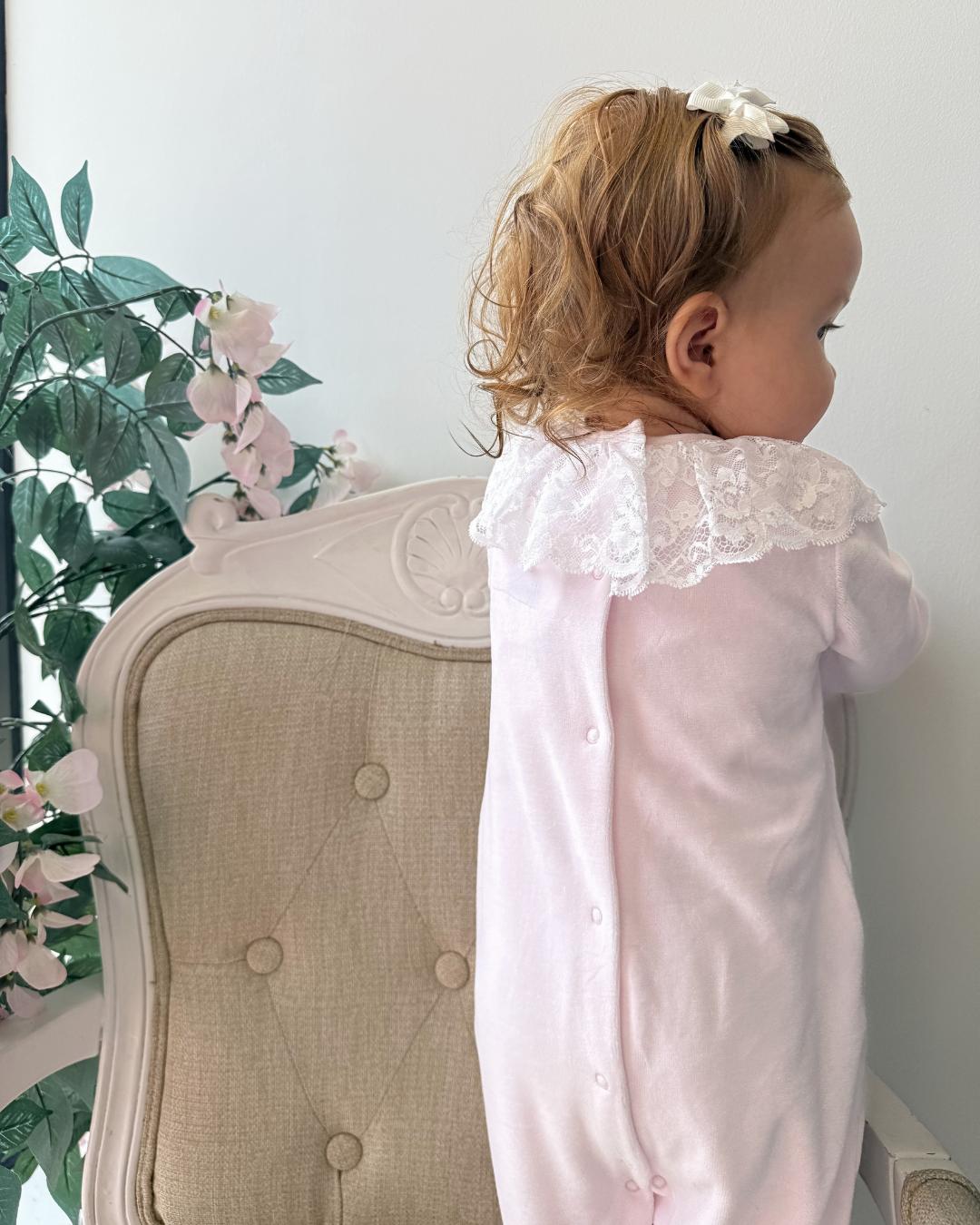 Bluesbaby Elodie Lace Velour Babygrow in baby pink with white lace frill collar, velvet bow and matching pink baby hat.