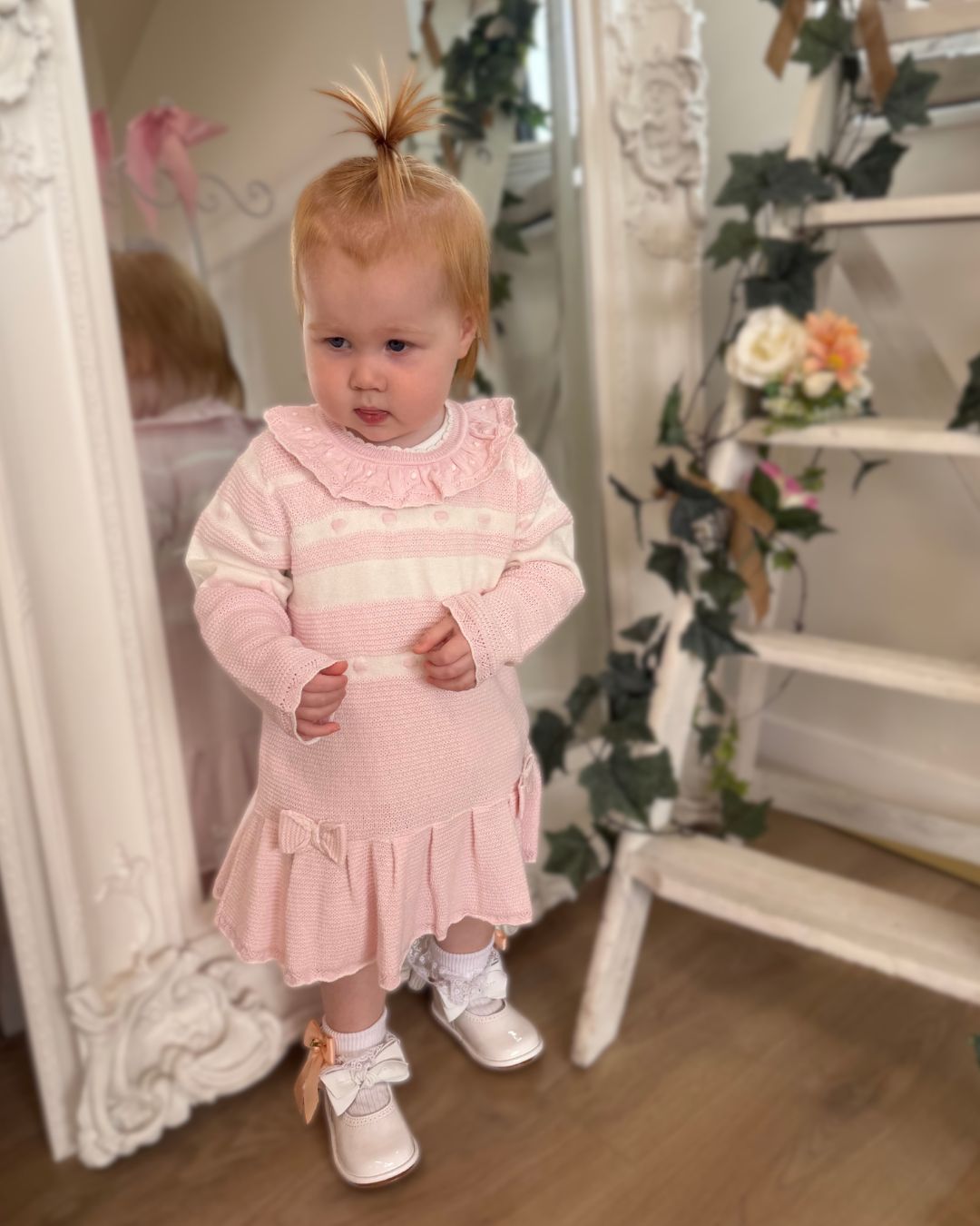 Bluesbaby Marie baby pink and cream knitted girls dress with frill collar, bows and pleated skirt.