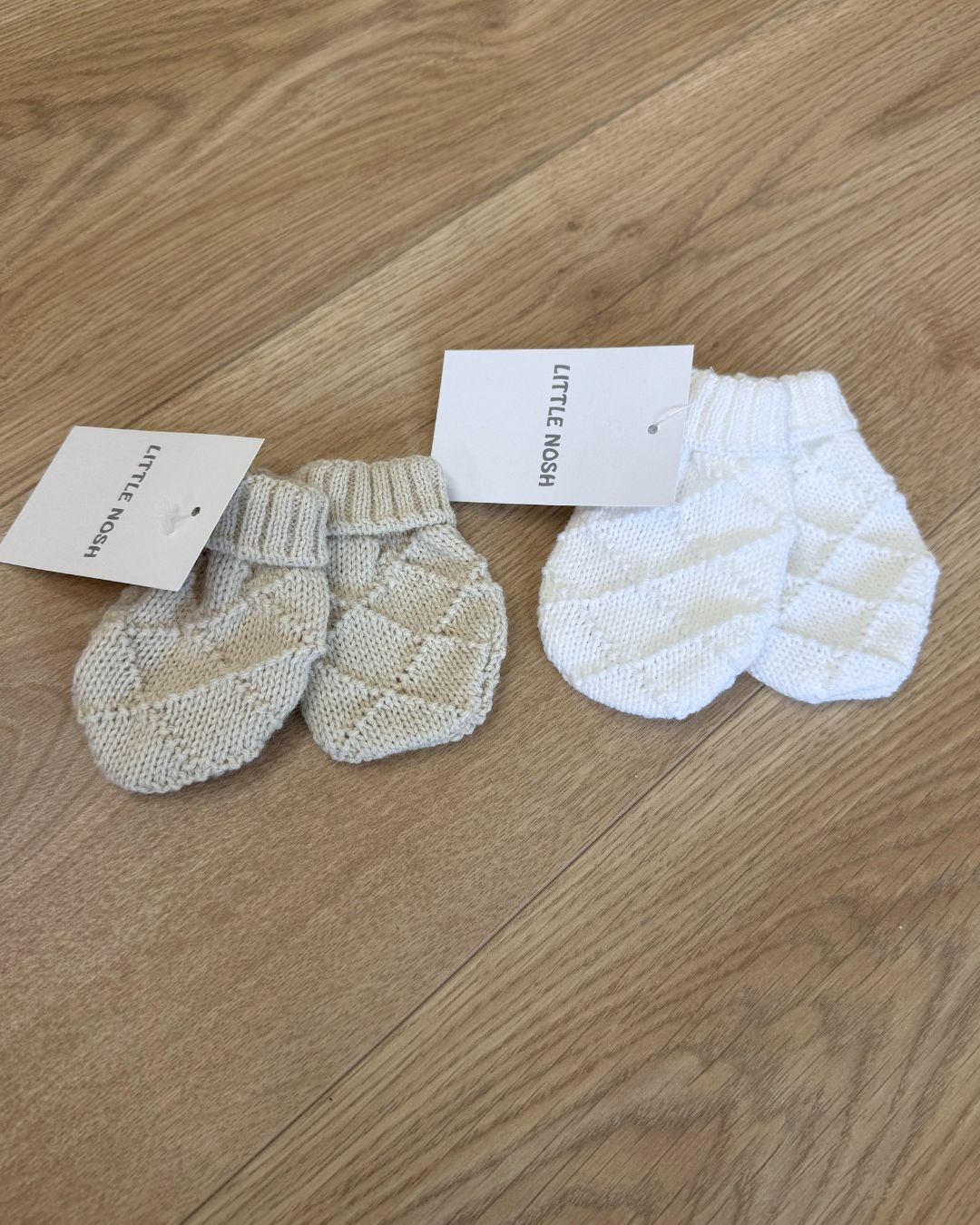 Little Nosh Hopscotch baby winter mittens with patterned knit and ribbed cuffs, available in white, biscuit brown and soft blue.
