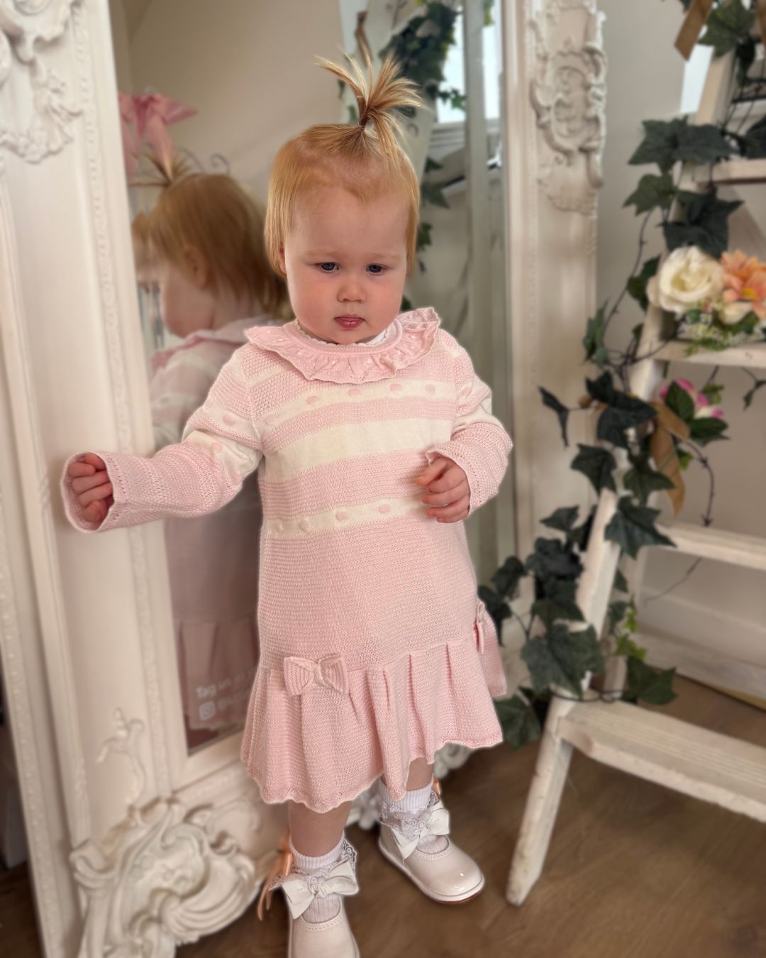 Bluesbaby Marie baby pink and cream knitted girls dress with frill collar, bows and pleated skirt.