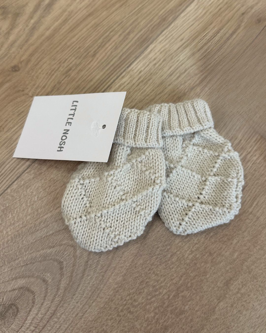 Little Nosh Hopscotch baby winter mittens with patterned knit and ribbed cuffs, available in white, biscuit brown and soft blue.