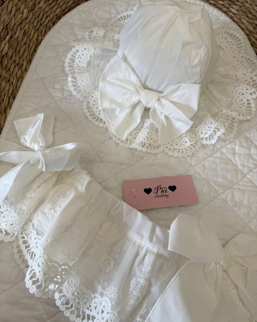 Phi Ivy Lace Sun Hat featuring soft ivory cotton, an embroidered lace brim and a large statement bow for baby girls.