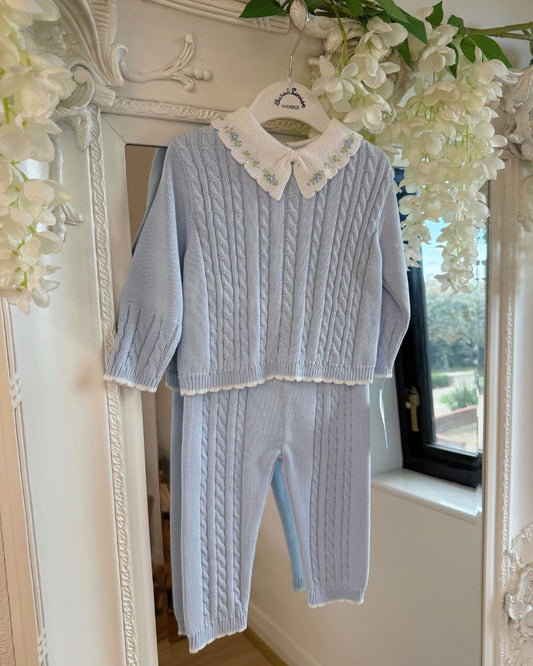 Sarah Louise Aster baby blue knitted trouser set with cable knit detailing and white floral embroidered collar.