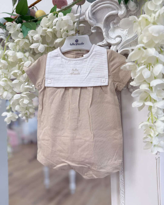 Tutto Piccolo Wren Romper featuring soft beige cotton, a striped bib-style collar, embroidered logo and classic pleated detailing.