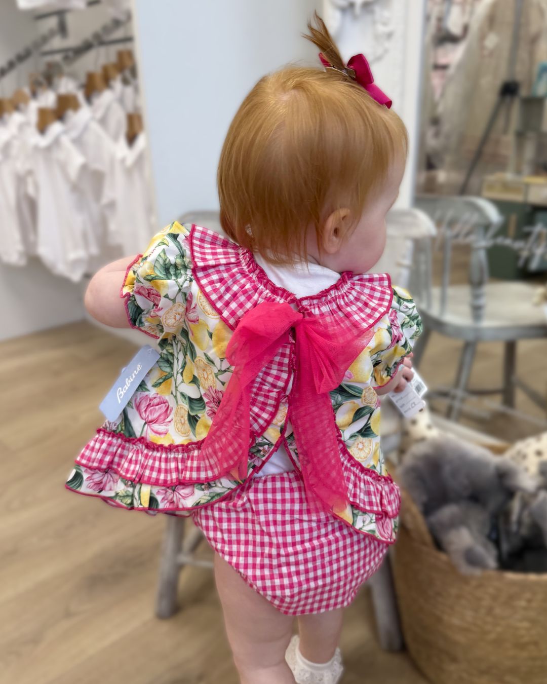 Babine Lemon Blossom Swing Back Dress & Pants featuring a lemon and pink floral print, open swing back, large tulle bow, frill collar, and matching pink gingham pants.