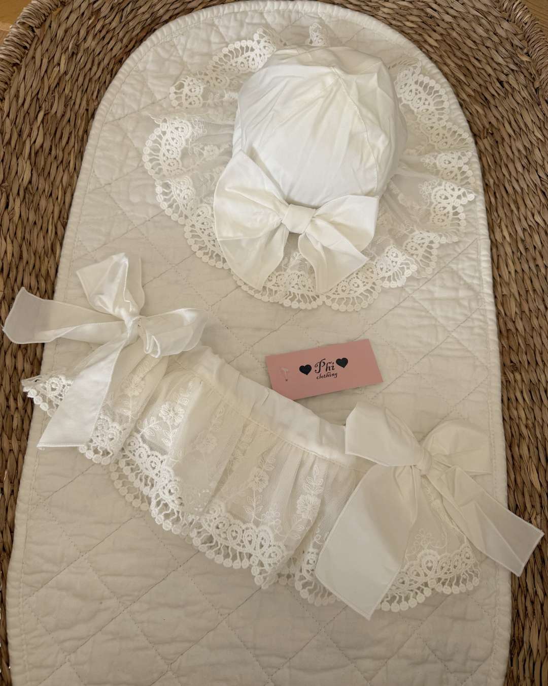 Phi Ivy Lace Jampants featuring soft ivory cotton, embroidered lace overskirt and oversized bows on each side. Paired with the matching Phi Ivy Lace Sun Hat.