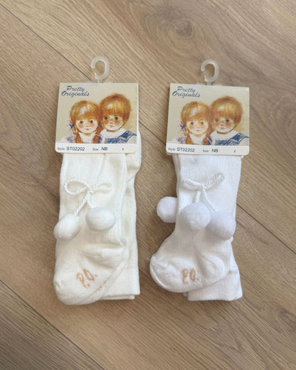 Pretty Originals unisex baby tights in white and ivory with soft pom pom detailing at the outer sides.