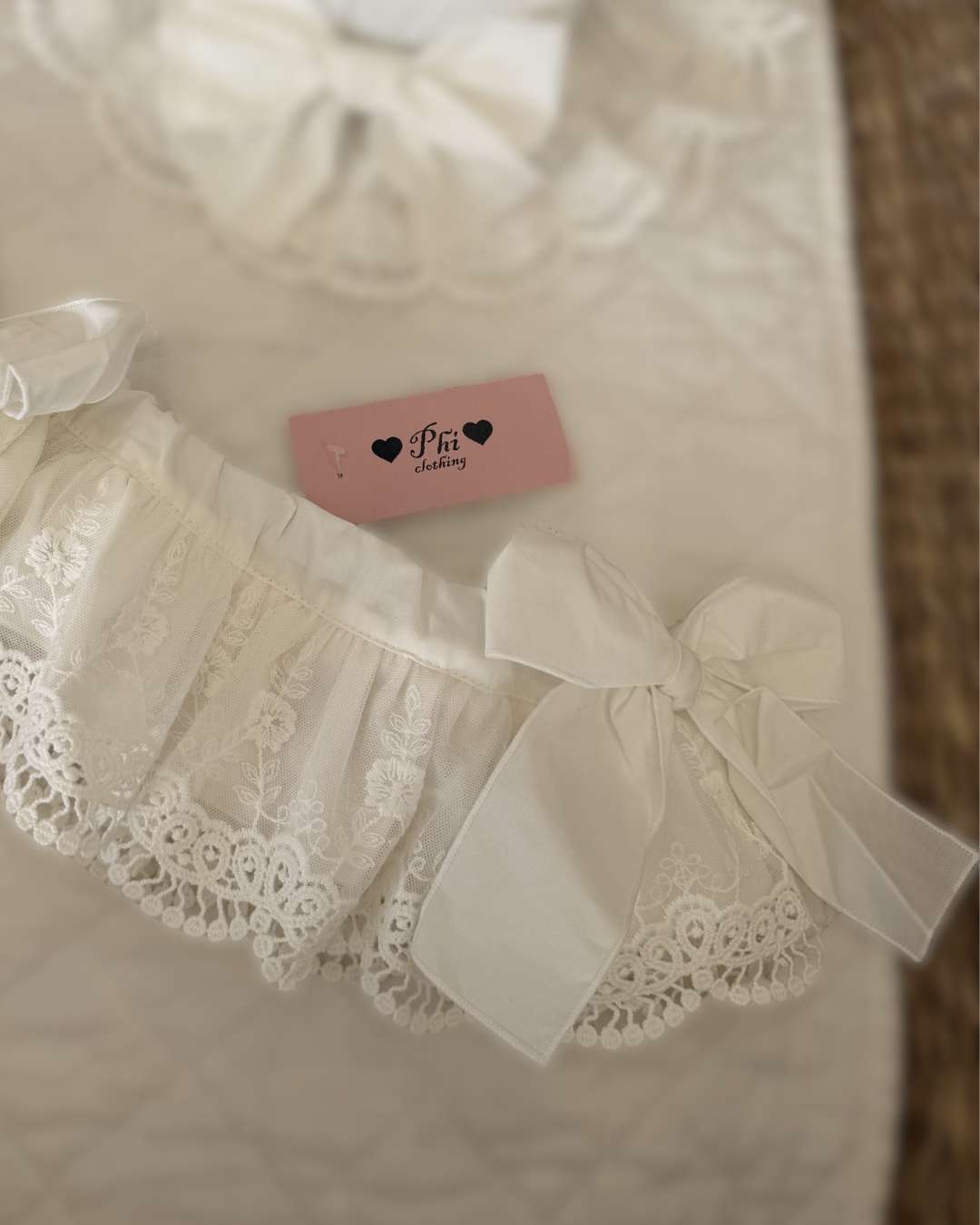 Phi Ivy Lace Jampants featuring soft ivory cotton, embroidered lace overskirt and oversized bows on each side.