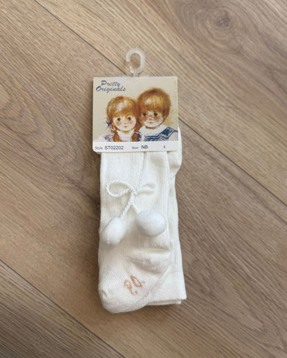 Pretty Originals unisex baby tights in white and ivory with soft pom pom detailing at the outer sides.