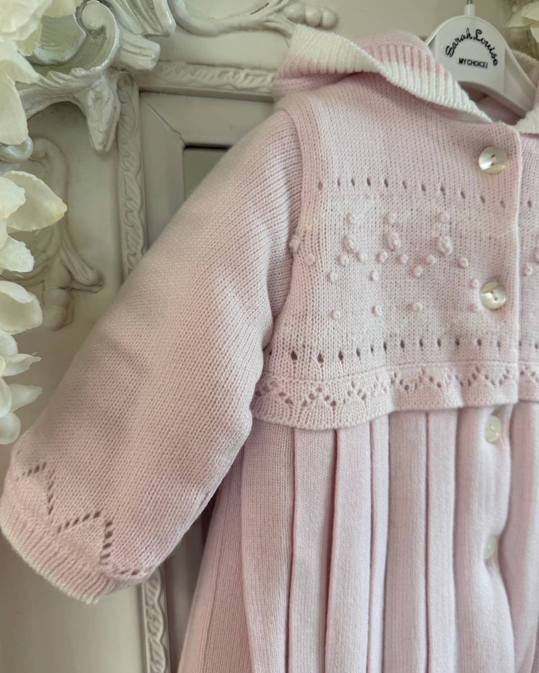 Sarah Louise Adeline pink double knit girls coat with hood, embroidered detailing, button fastening and pleated skirt.