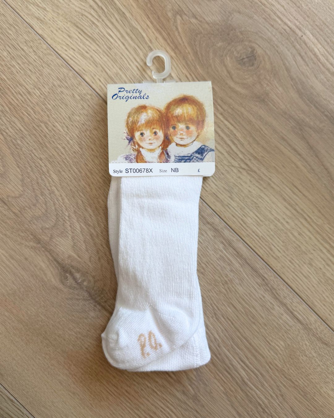 Pretty Originals plain white unisex children’s tights for baby boys and girls.
