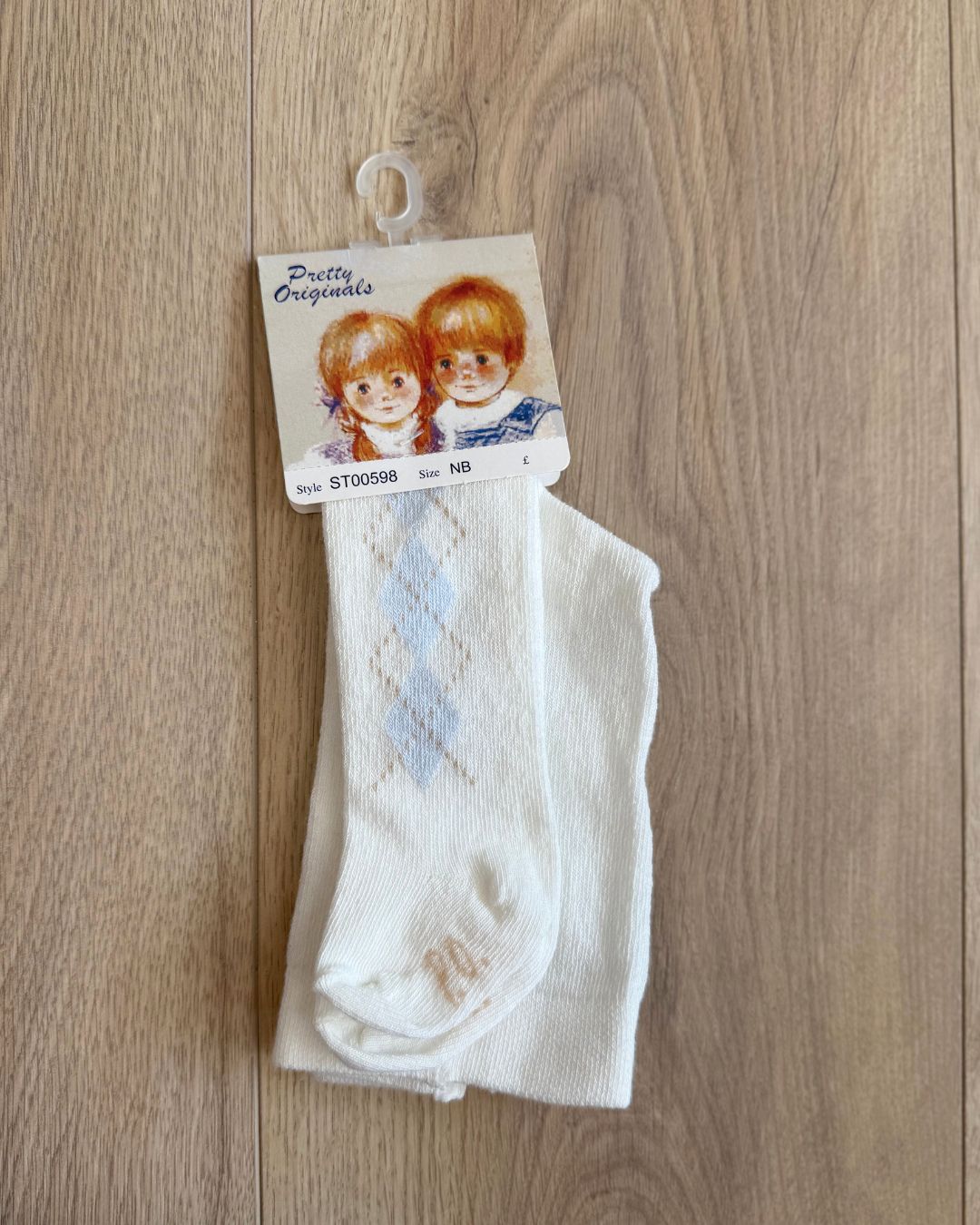Pretty Originals cream boys tights with blue and beige argyle pattern running down the outer sides.