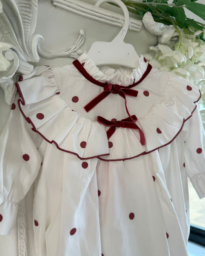 Phi Juliet ivory baby girls romper with red polka dots, frilled collar and red velvet bows.