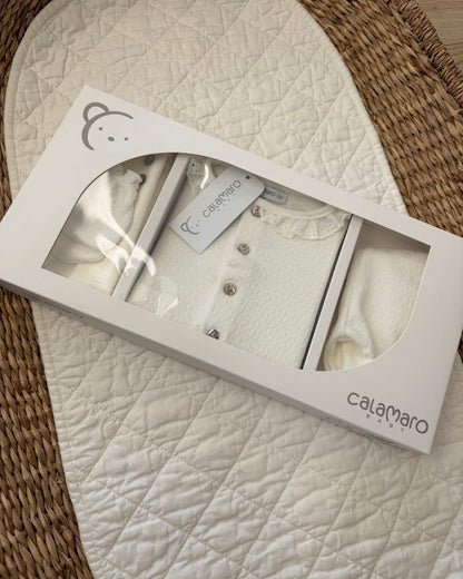 Calamaro Pearl ivory newborn baby girl gift set featuring a lace collar button-up top, matching footed trousers, baby mittens, hat and Calamaro signature baby perfume.