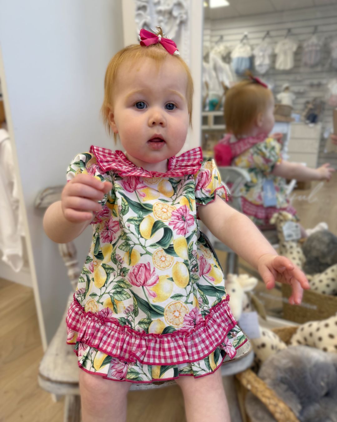 Babine Lemon Blossom Swing Back Dress & Pants featuring a lemon and pink floral print, open swing back, large tulle bow, frill collar, and matching pink gingham pants.