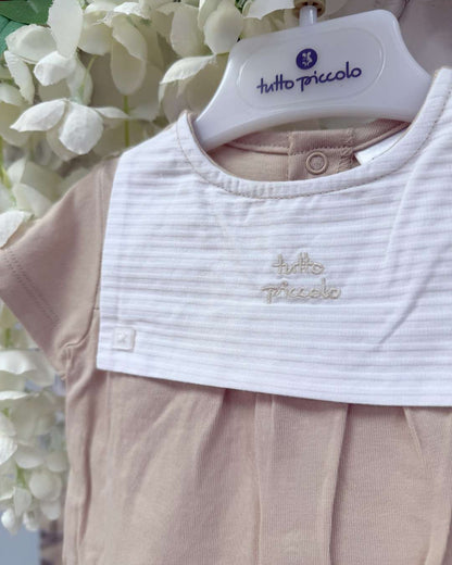 Tutto Piccolo Wren Romper featuring soft beige cotton, a striped bib-style collar, embroidered logo and classic pleated detailing.