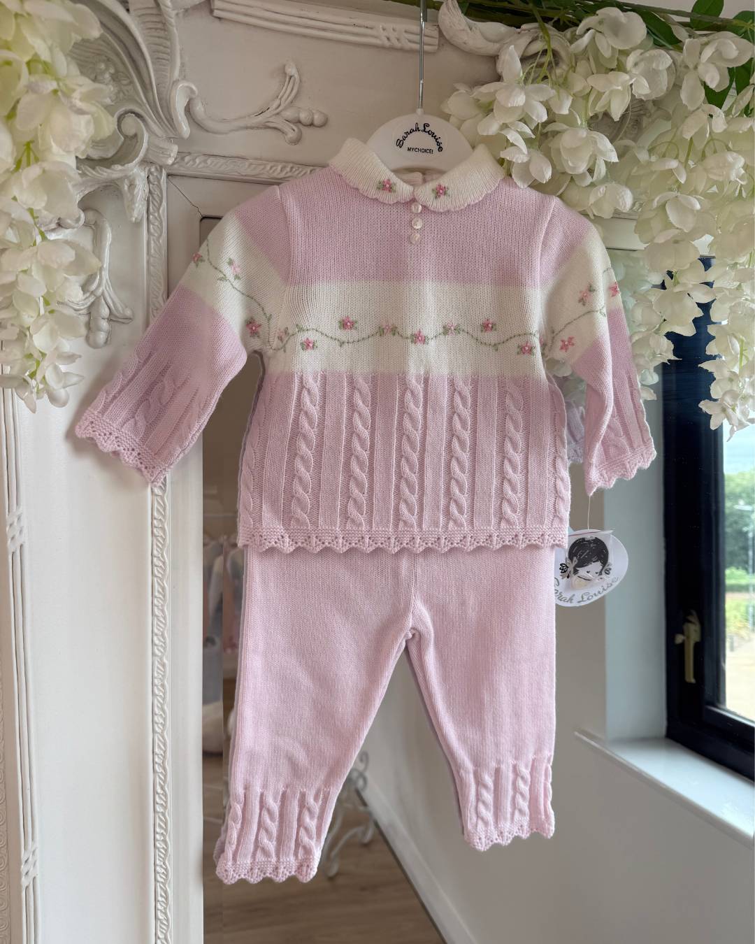 Sarah Louise Madelyn pink knitted girls trouser set with white Peter Pan collar, floral embroidery and cable knit detailing.