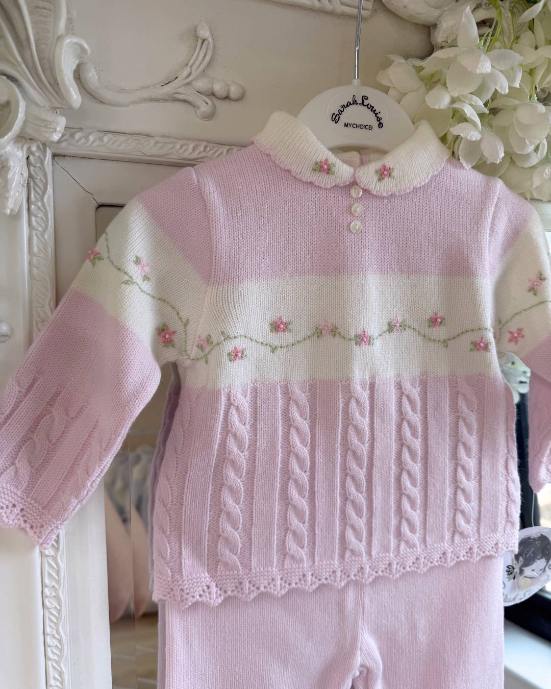Sarah Louise Madelyn pink knitted girls trouser set with white Peter Pan collar, floral embroidery and cable knit detailing.