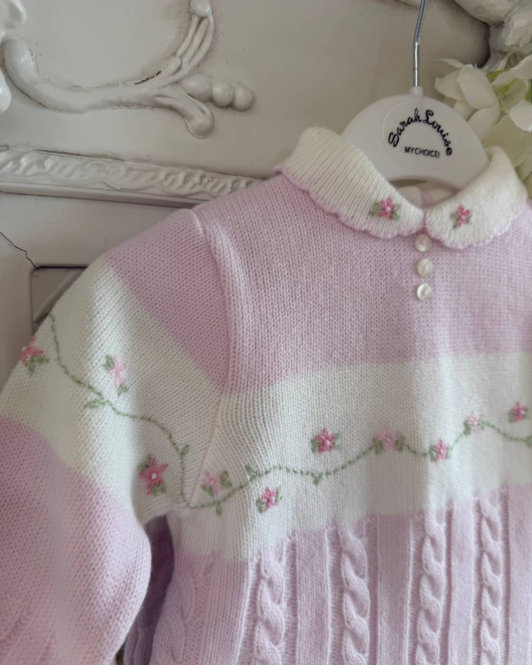 Sarah Louise Madelyn pink knitted girls trouser set with white Peter Pan collar, floral embroidery and cable knit detailing.