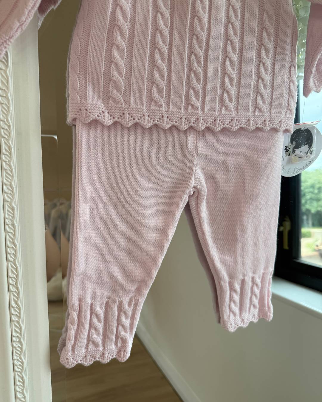 Sarah Louise Madelyn pink knitted girls trouser set with white Peter Pan collar, floral embroidery and cable knit detailing.