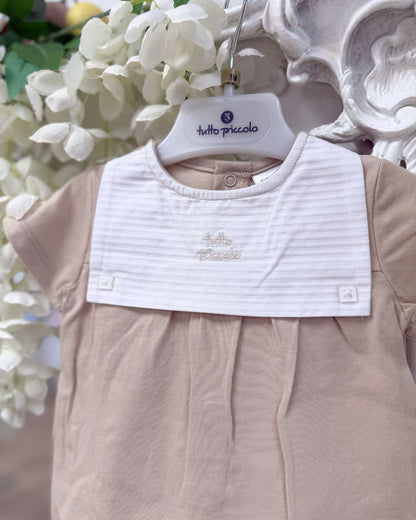 Tutto Piccolo Wren Romper featuring soft beige cotton, a striped bib-style collar, embroidered logo and classic pleated detailing.