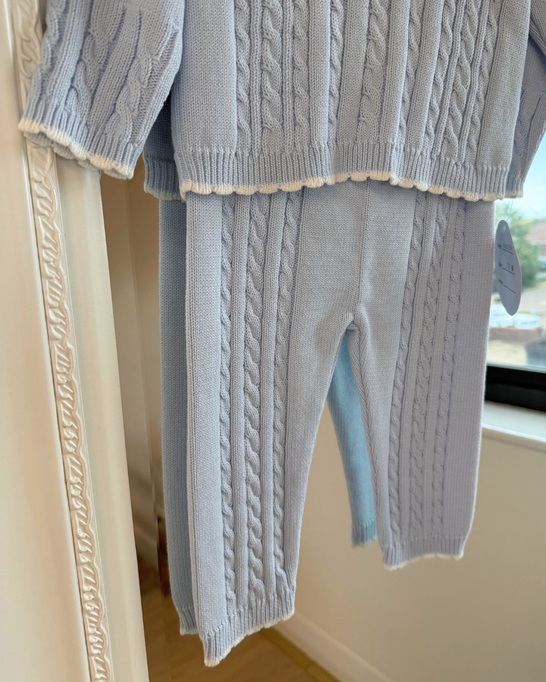 Sarah Louise Aster baby blue knitted trouser set with cable knit detailing and white floral embroidered collar.