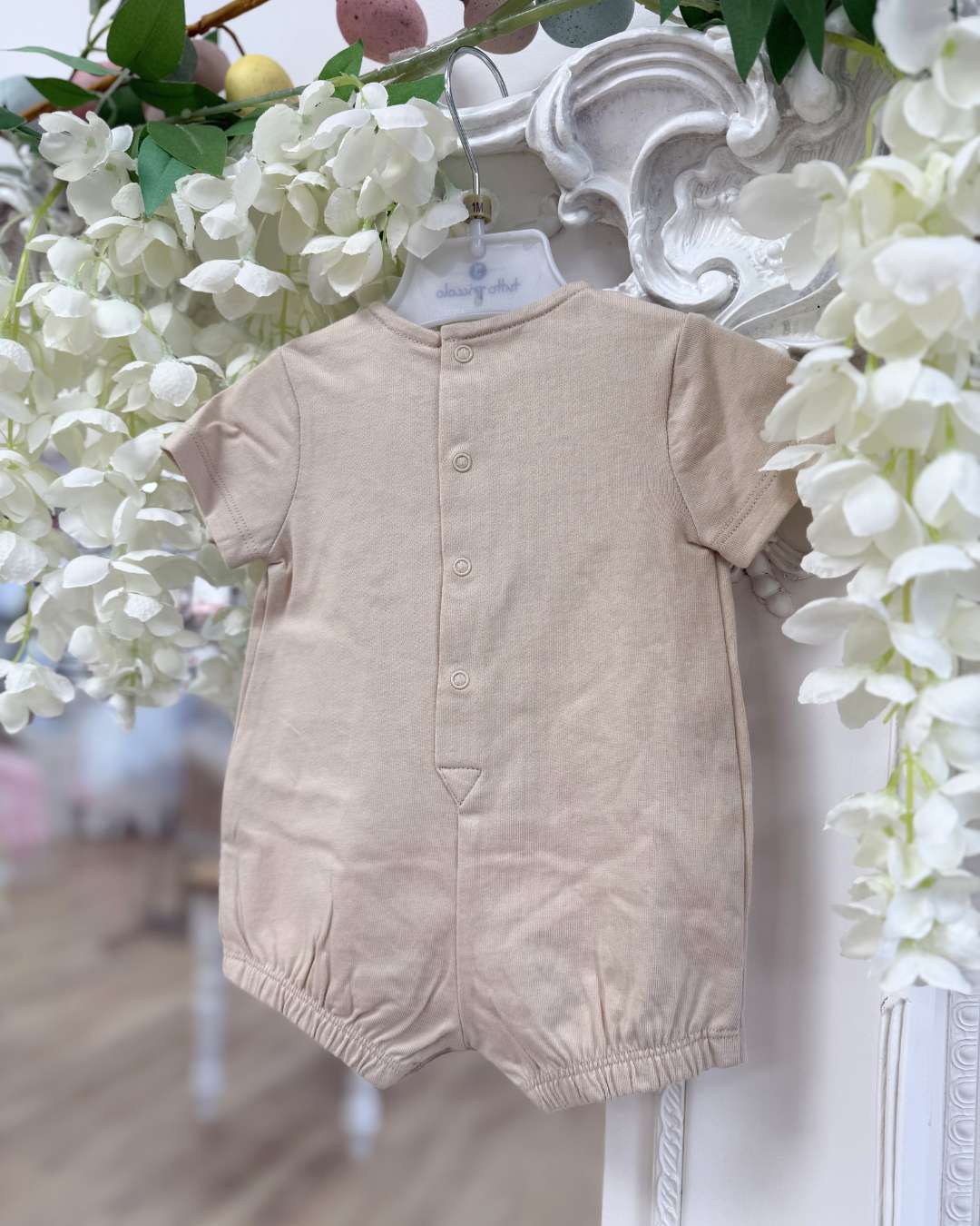Tutto Piccolo Wren Romper featuring soft beige cotton, a striped bib-style collar, embroidered logo and classic pleated detailing.