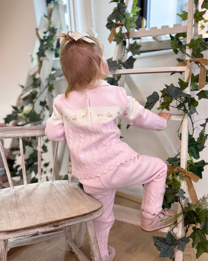 Sarah Louise Madelyn pink knitted girls trouser set with white Peter Pan collar, floral embroidery and cable knit detailing.
