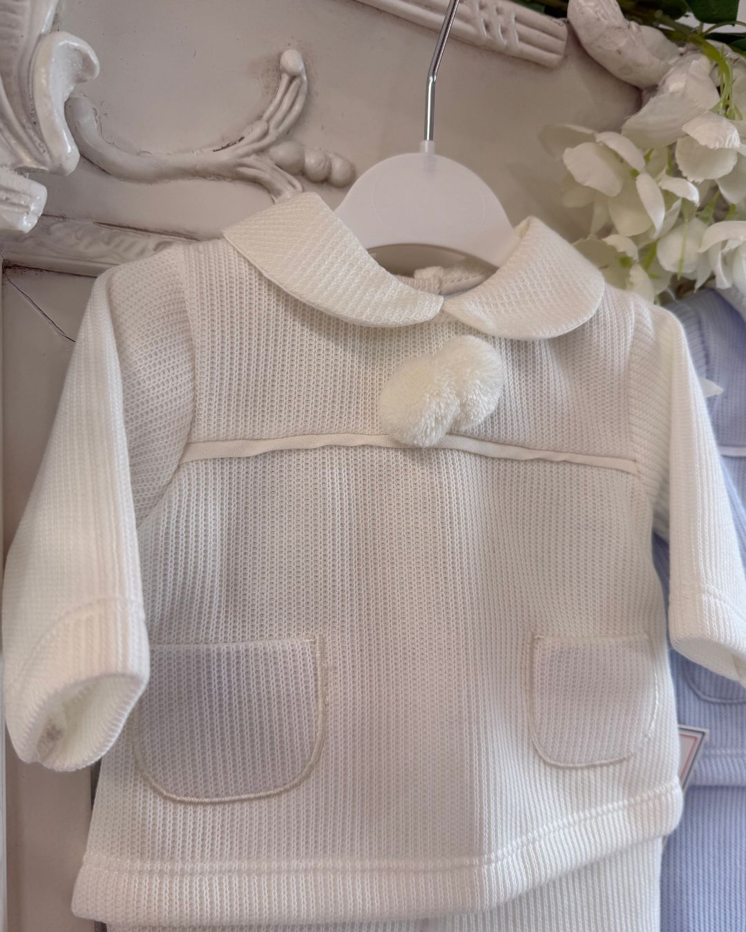 Baby knitted pom pom top and footed trouser set in ivory, baby blue and baby pink.