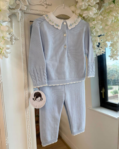 Sarah Louise Aster baby blue knitted trouser set with cable knit detailing and white floral embroidered collar.