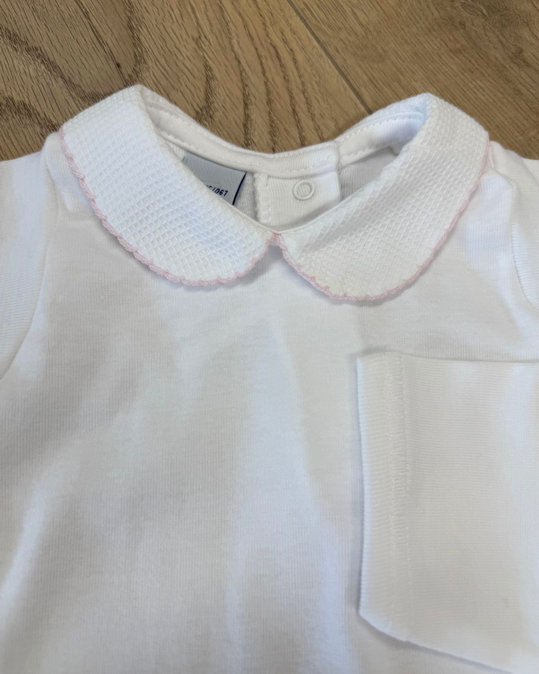 Babidu white unisex baby bodysuit with Peter Pan collar and coloured stitch trim.