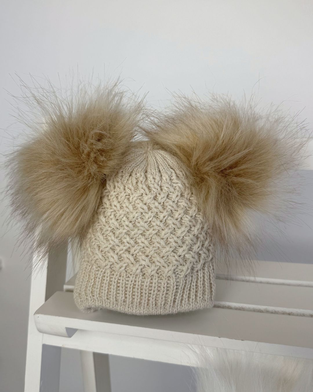 Little Nosh Curly Knit baby winter hat with twin faux fur pom poms, basketweave knit and cosy ear covers.