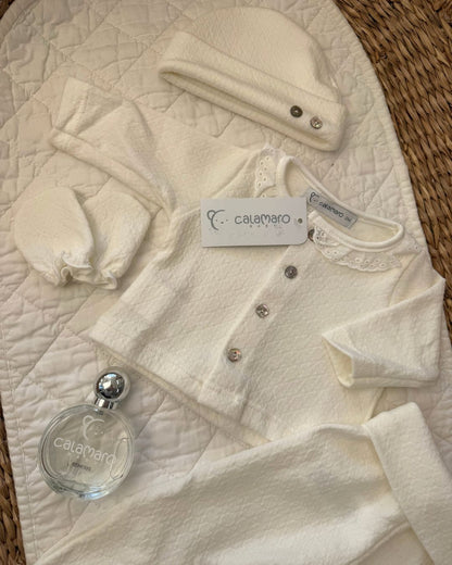 Calamaro Pearl ivory newborn baby girl gift set featuring a lace collar button-up top, matching footed trousers, baby mittens, hat and Calamaro signature baby perfume.