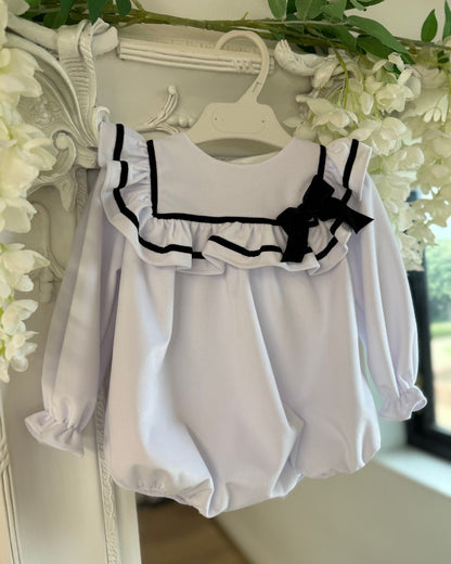 Fofettes X Be Chic Alba white velvet baby girls romper with sailor frill collar, black trim and velvet bow.