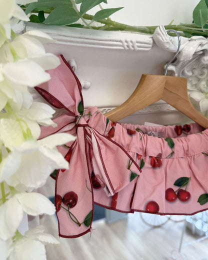 Phi pink jampants with a cherry print, a frill skirt overlay and two large side bows