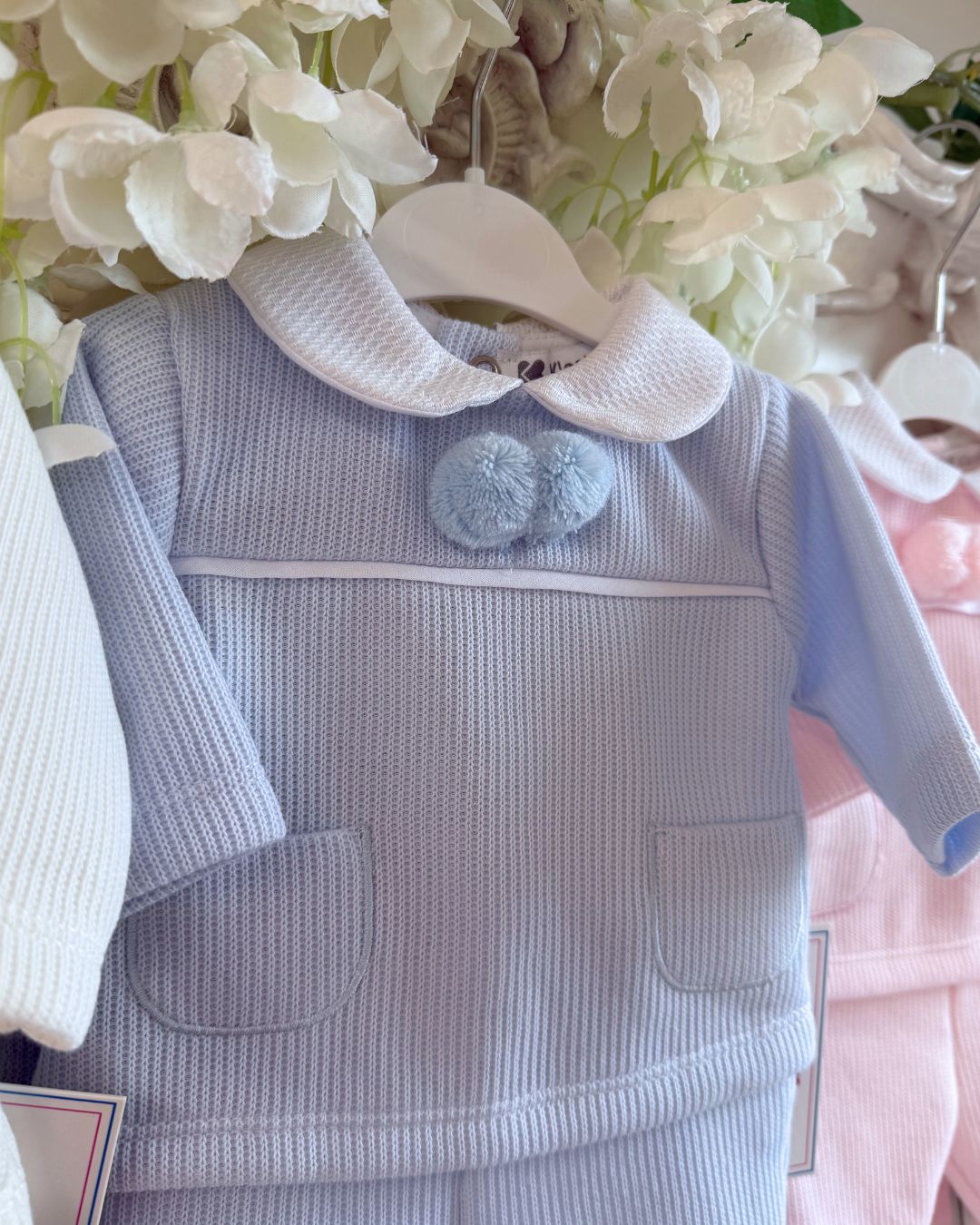 Baby knitted pom pom top and footed trouser set in ivory, baby blue and baby pink.