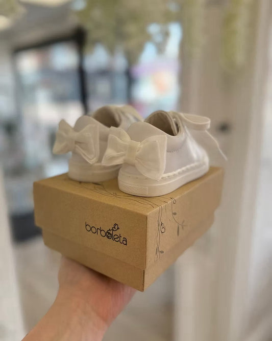 Borboleta Sara Bow Trainers featuring white leather, double velvet bows at the back, stitched rubber sole and classic lace-up design.