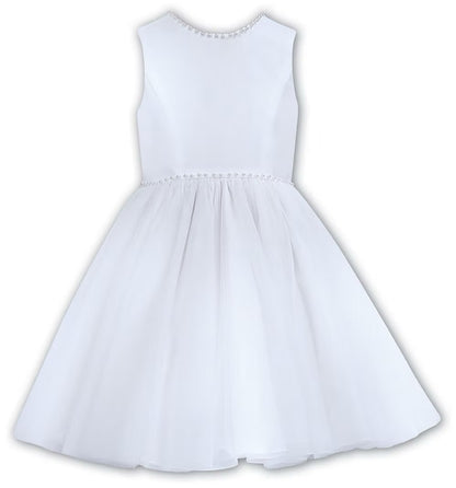 Sarah Louise White Pearl Ballerina Dress featuring a soft peach tone, pearl-trimmed neckline, full layered tulle skirt and statement V-back bow.