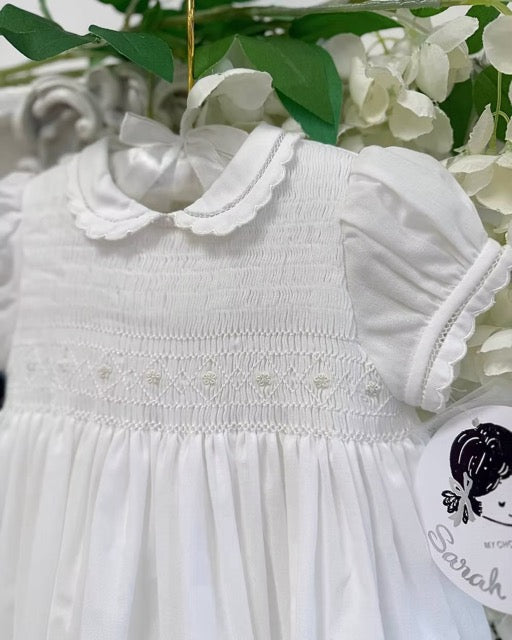 Sarah Louise Philippa Christening Gown & Bonnet featuring hand-smocked floral embroidery, pearl details, scalloped trims and a matching bonnet.