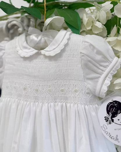 Sarah Louise Philippa Christening Gown & Bonnet featuring hand-smocked floral embroidery, pearl details, scalloped trims and a matching bonnet.