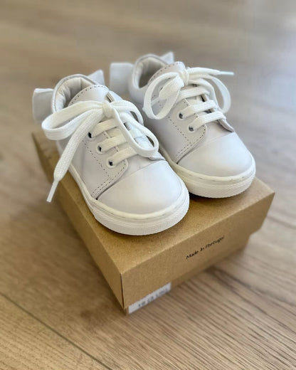 Borboleta Sara Bow Trainers featuring white leather, double velvet bows at the back, stitched rubber sole and classic lace-up design.
