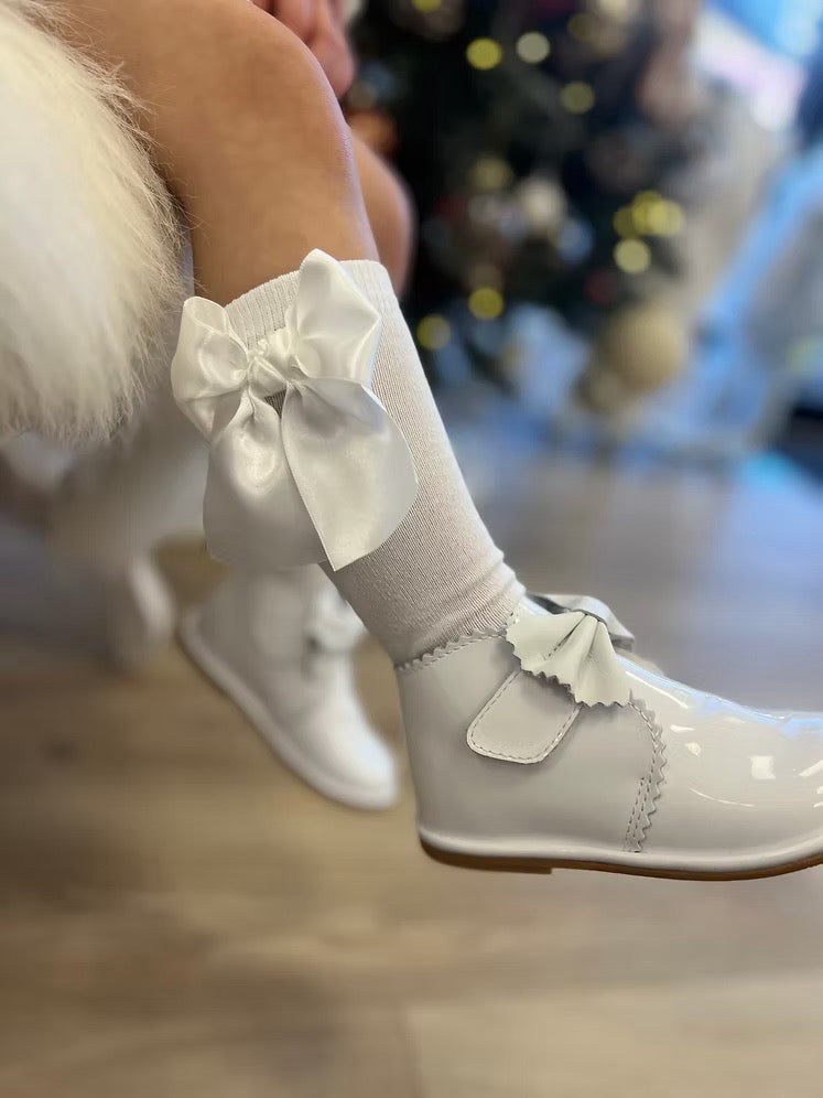 Borboleta Sharon Boot featuring white patent leather, front bow detail, Velcro fastening, anti-slip sole and a wide G/H fit.