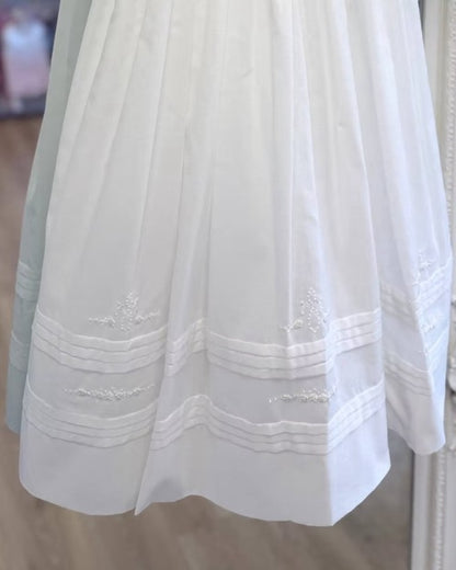 Sarah Louise Philippa Christening Gown & Bonnet featuring hand-smocked floral embroidery, pearl details, scalloped trims and a matching bonnet.