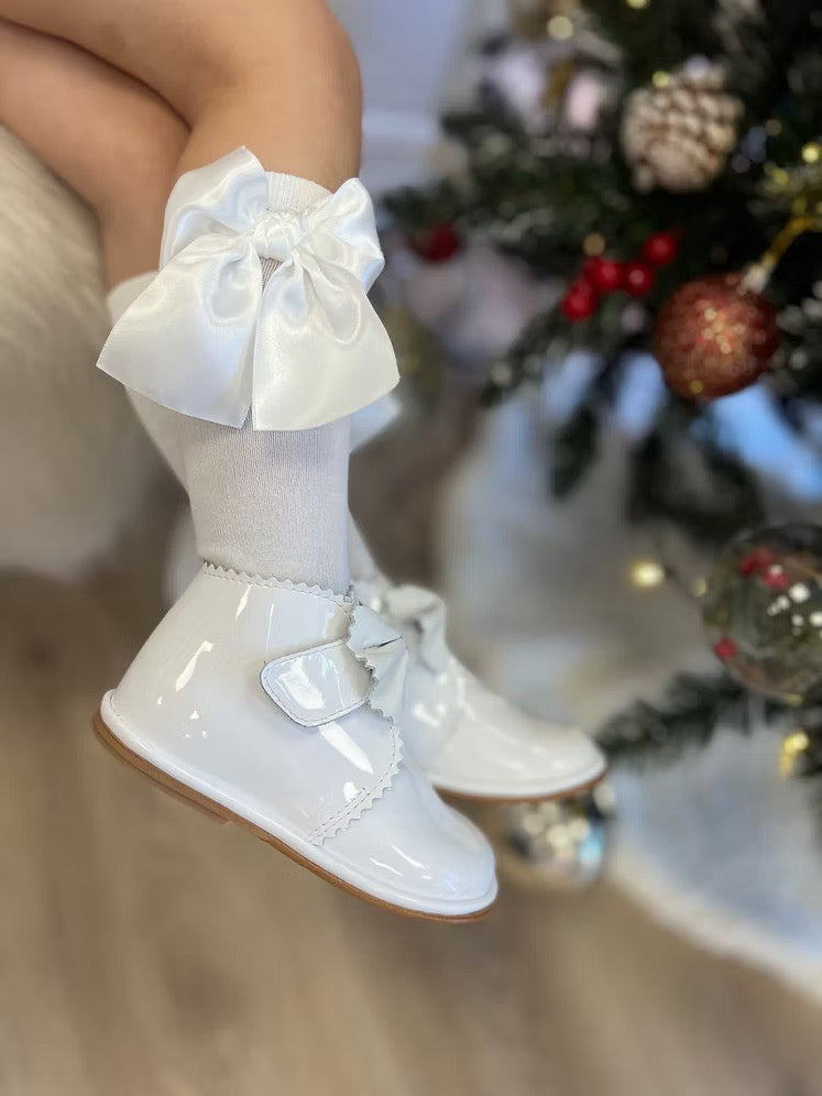 Borboleta Sharon Boot featuring white patent leather, front bow detail, Velcro fastening, anti-slip sole and a wide G/H fit.
